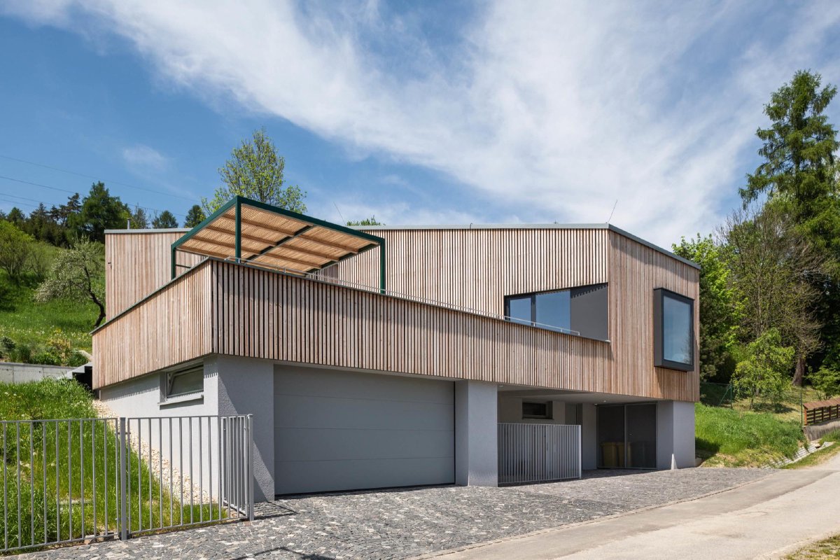 Moderní dřevostavba s lamelovou fasádou a garáží — pohled z ulice