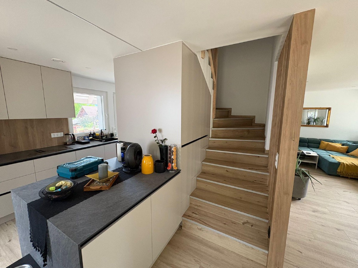 Kitchen and living area interior of Rothrist smart home