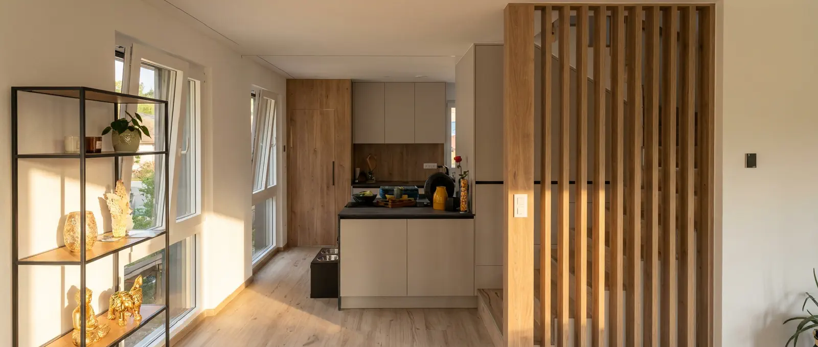 Open-plan kitchen with wood staircase, Rothrist smart home